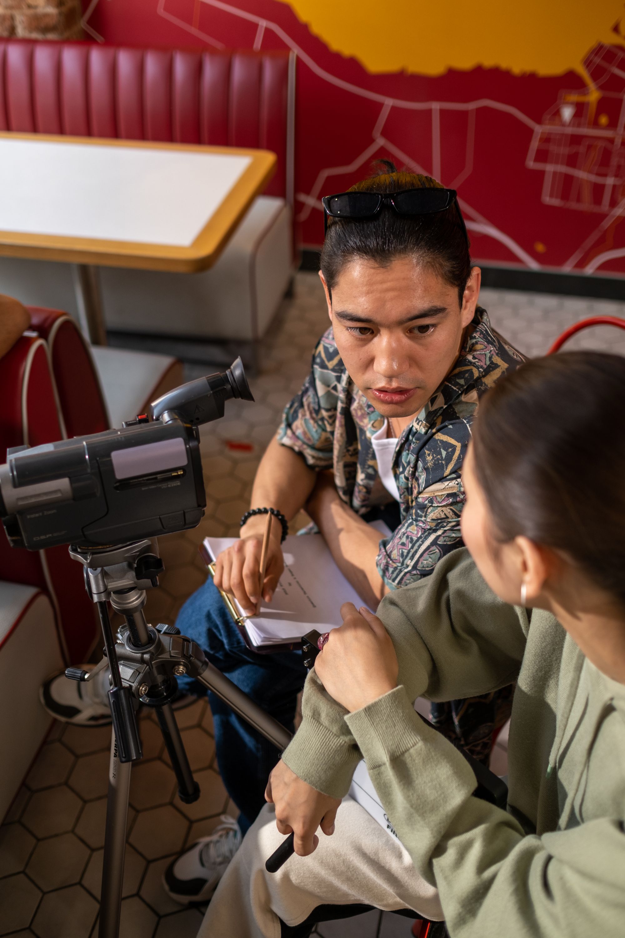 A director and camera operator planning a scene beside the camera