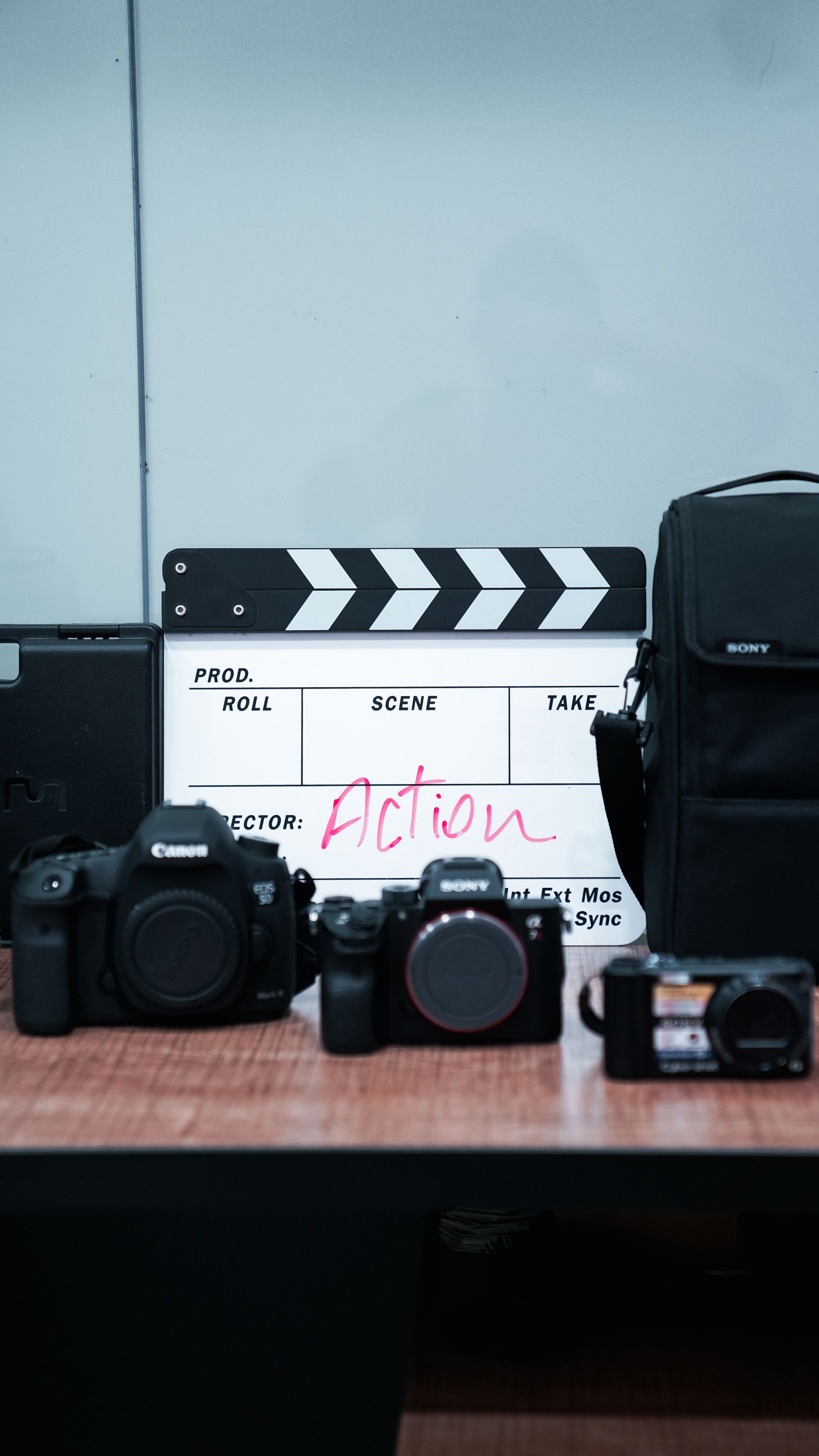 Cameras and a clapperboard arranged for production planning