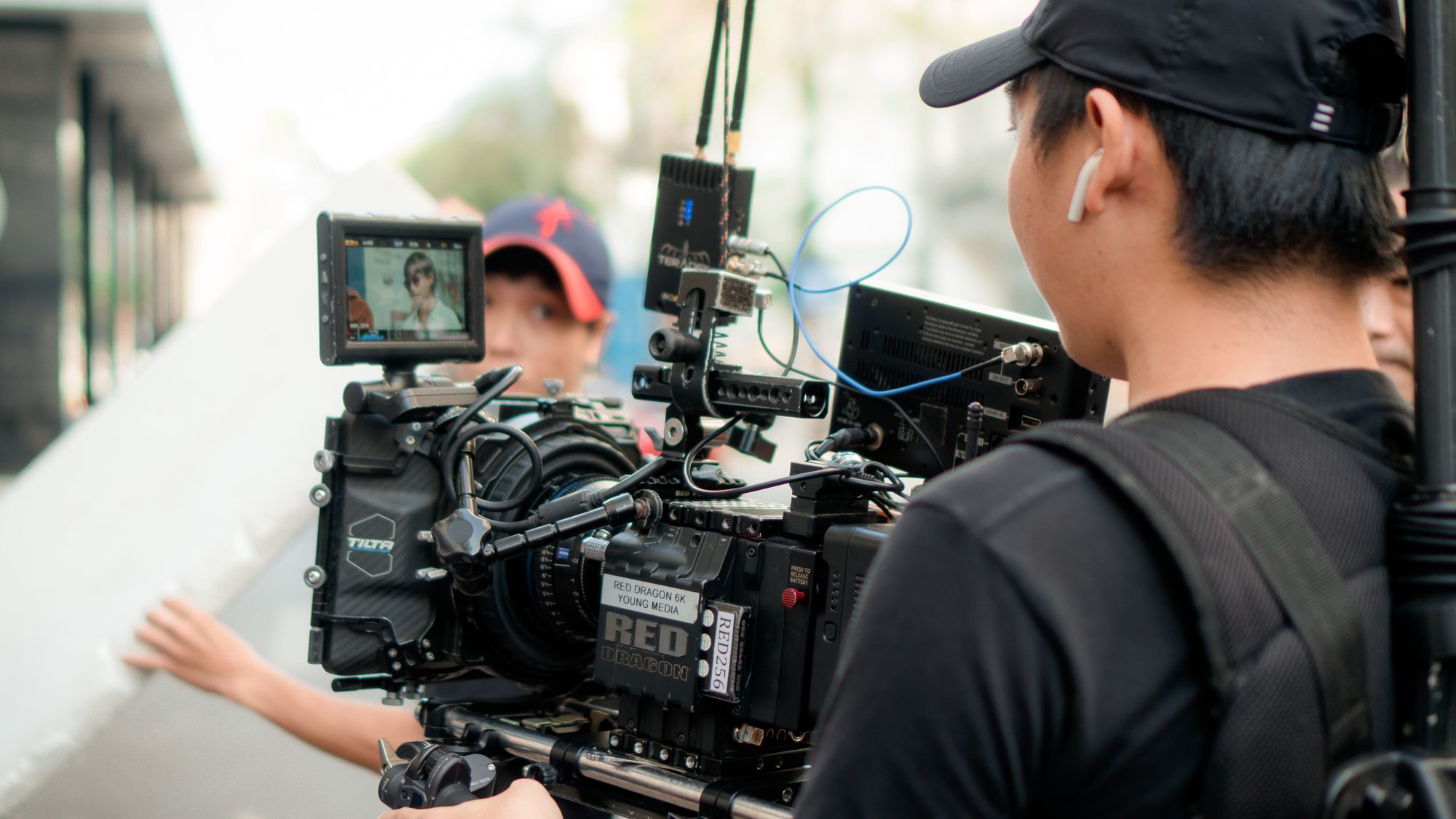 A cinematographer operating a professional camera on location