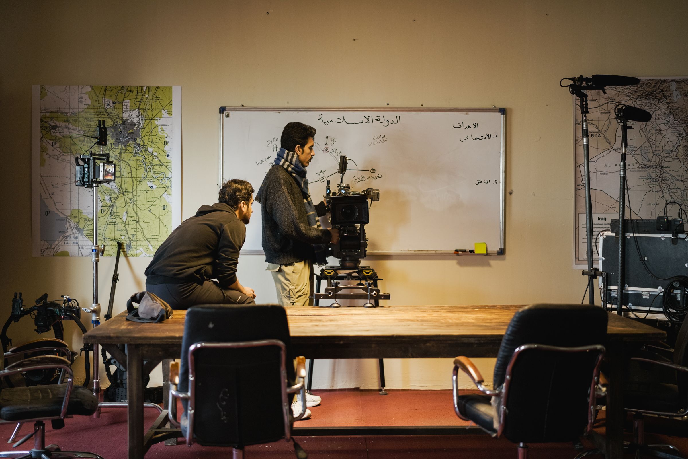 A film crew preparing a cinema camera on an active set