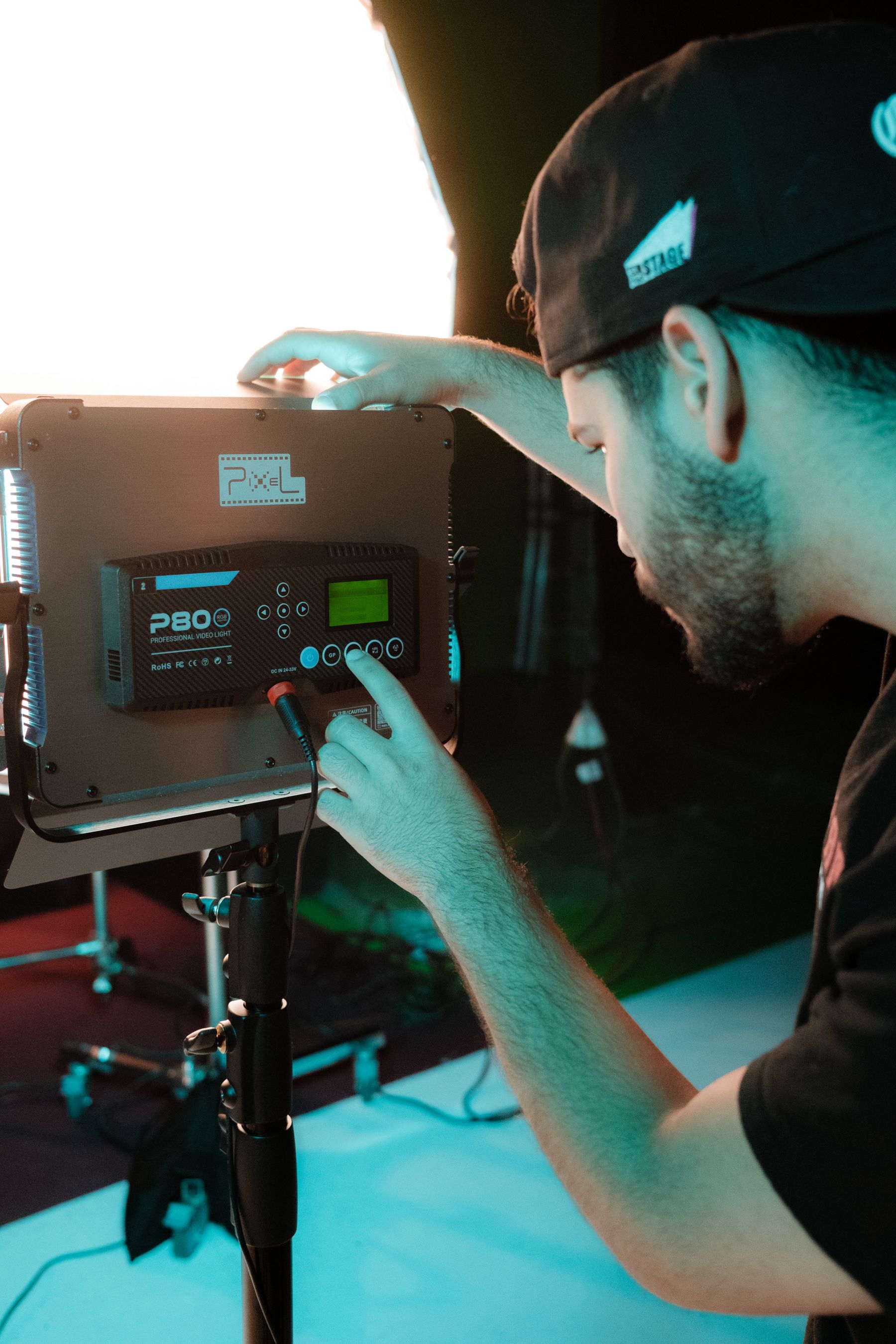 Crew member adjusting a production light