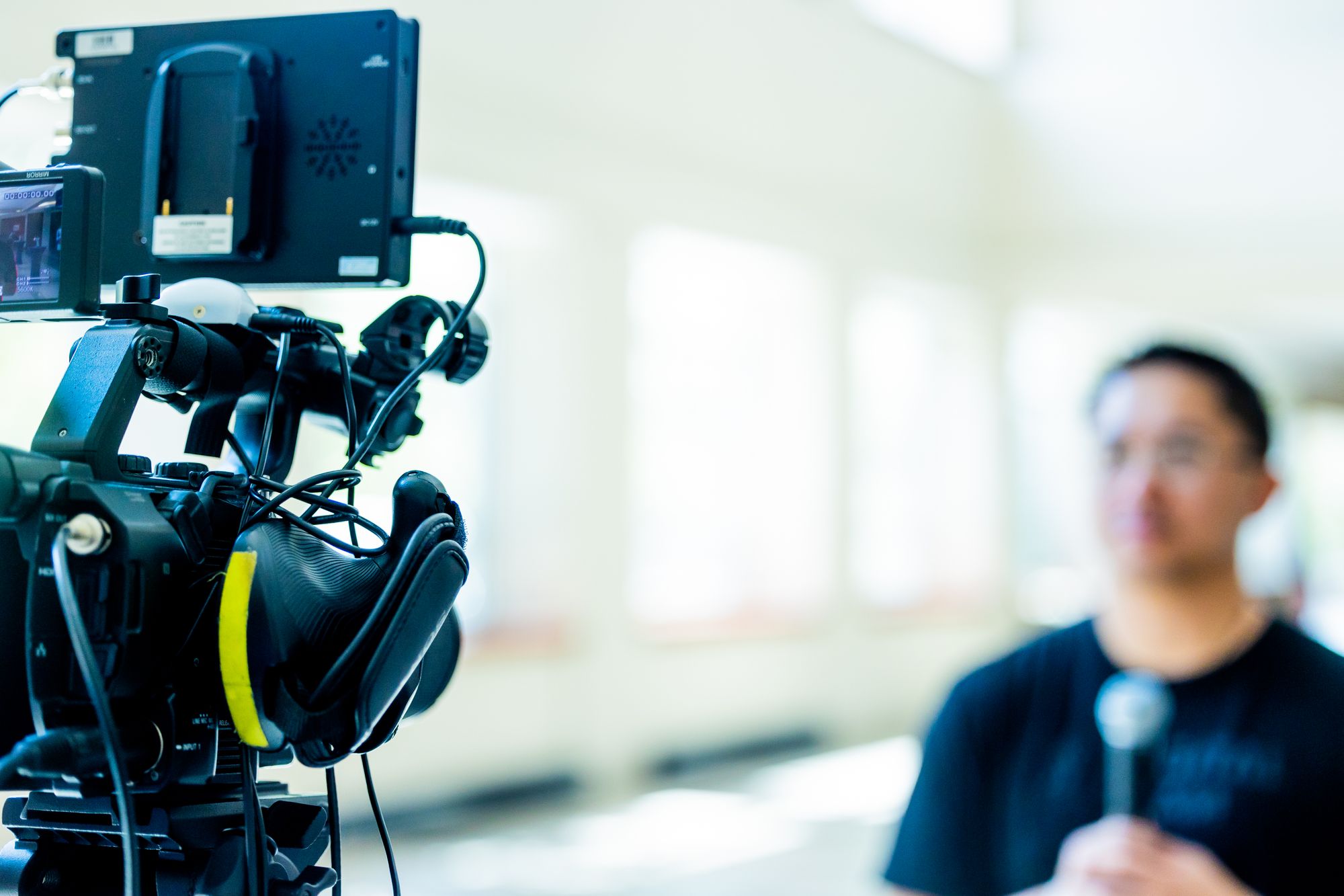 A professional cinema camera framing an interview